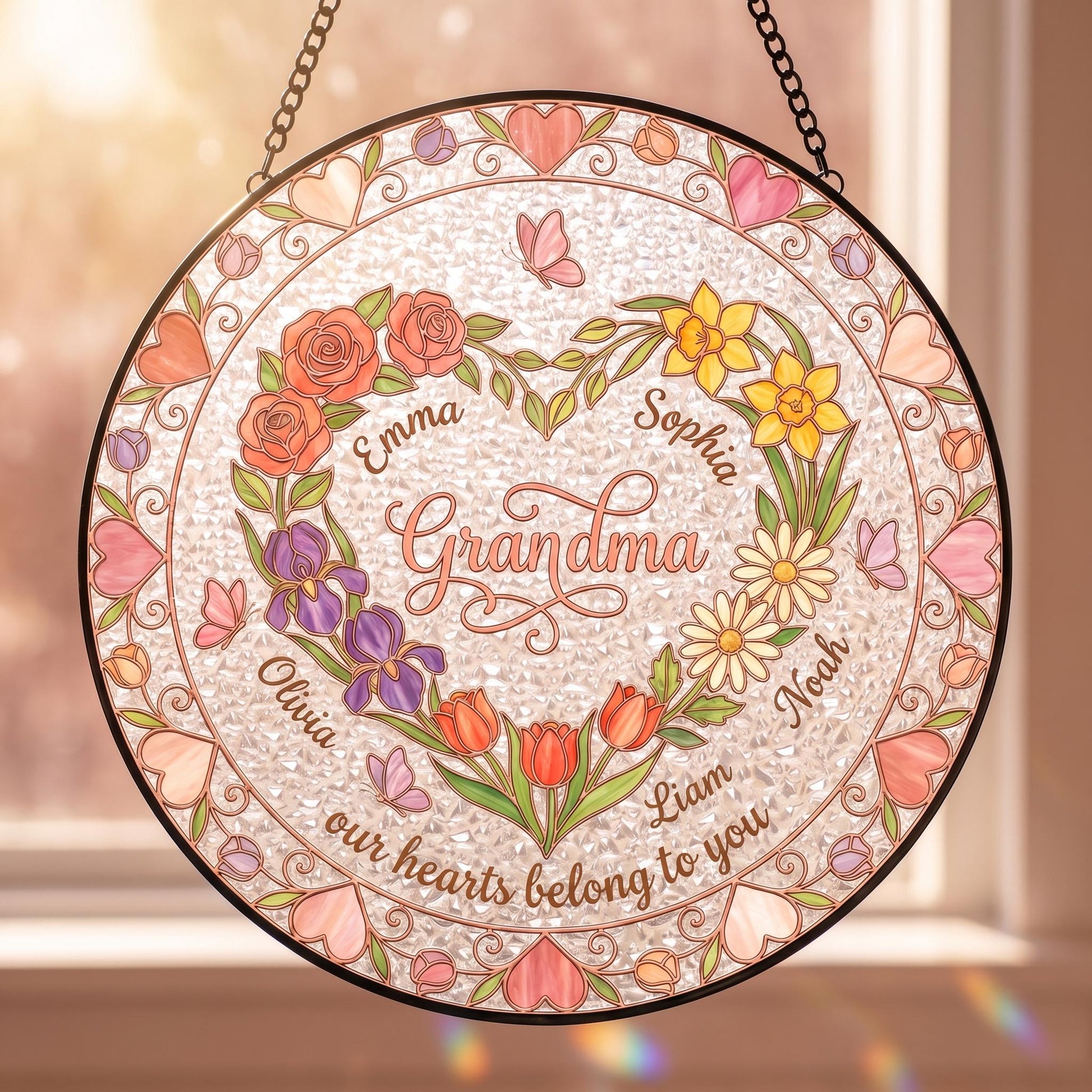 Heart garden suncatcher with birth flowers and names on white background, rose gold lead lines and romantic stained glass design