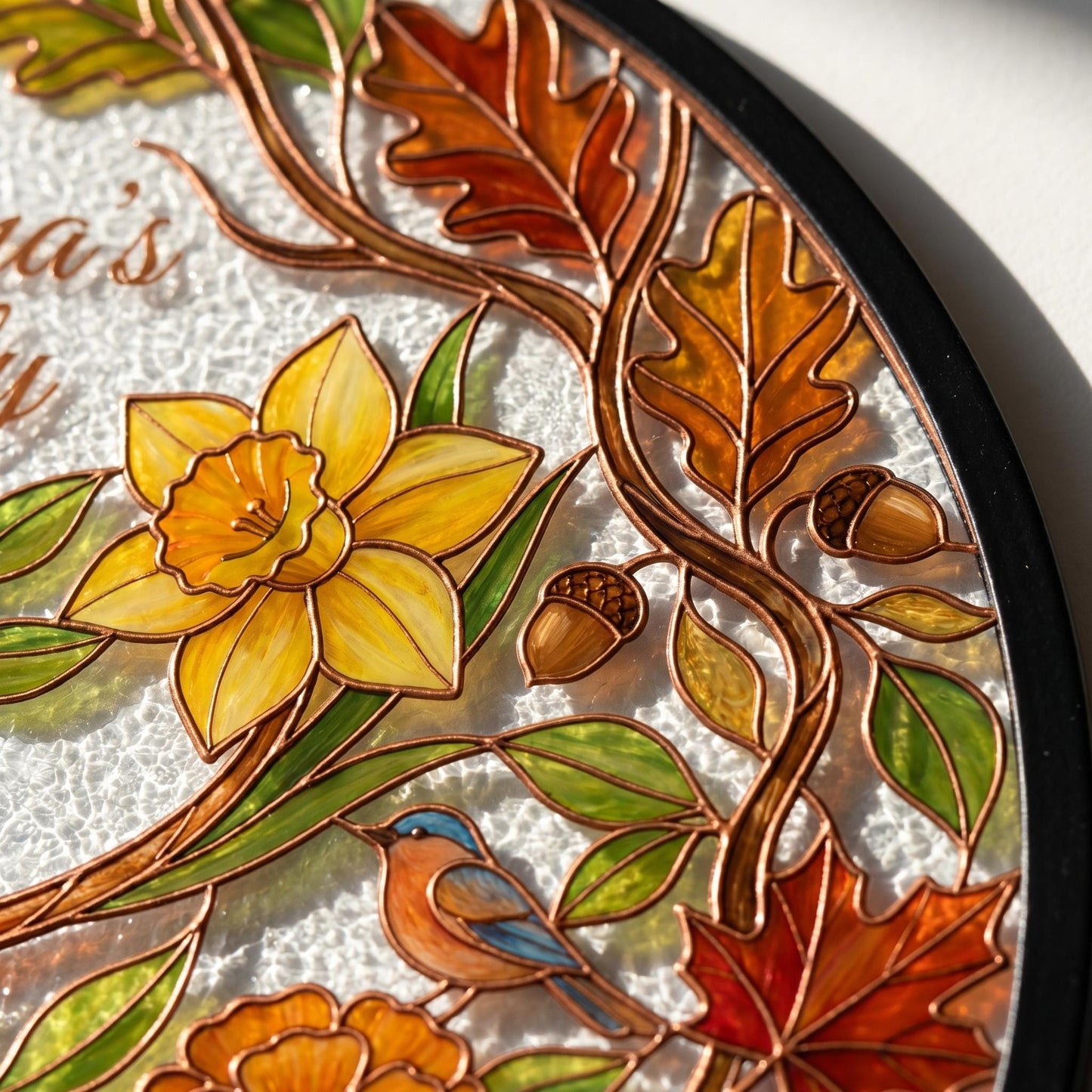 Close-up of Family Tree suncatcher showing copper-bronze UV-printed lead lines, oak and maple leaf border, birth flower glass texture