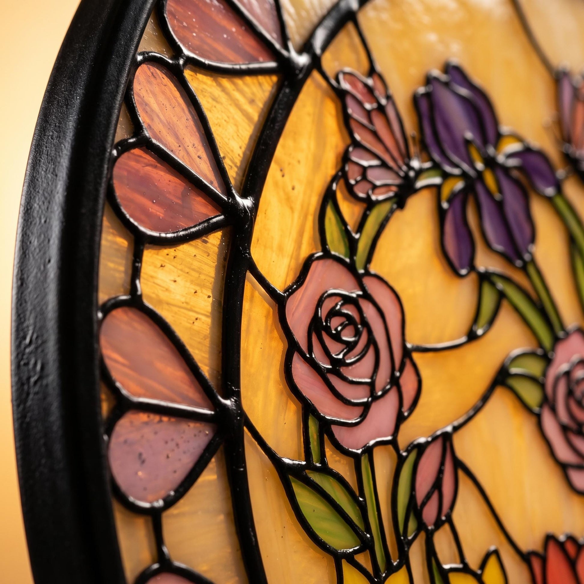 Close-up detail of pink and lavender glass heart border with visible solder bumps and handcrafted stained glass rose