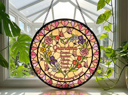 Grandma heart suncatcher hanging in white garden gazebo surrounded by pink rose bushes at golden hour