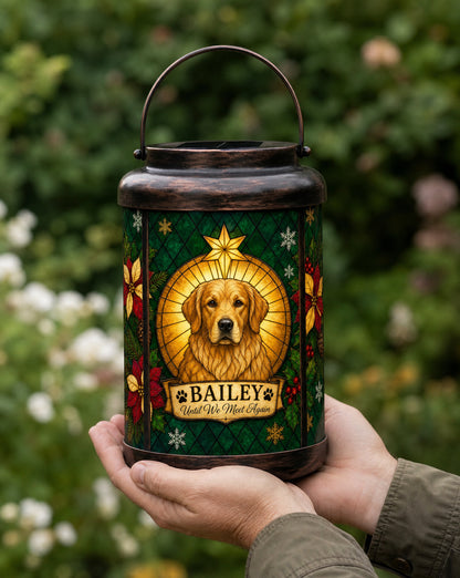 Hands holding a personalized pet Christmas memorial solar lantern outdoors to show its real size, with a custom golden retriever portrait and the name Bailey