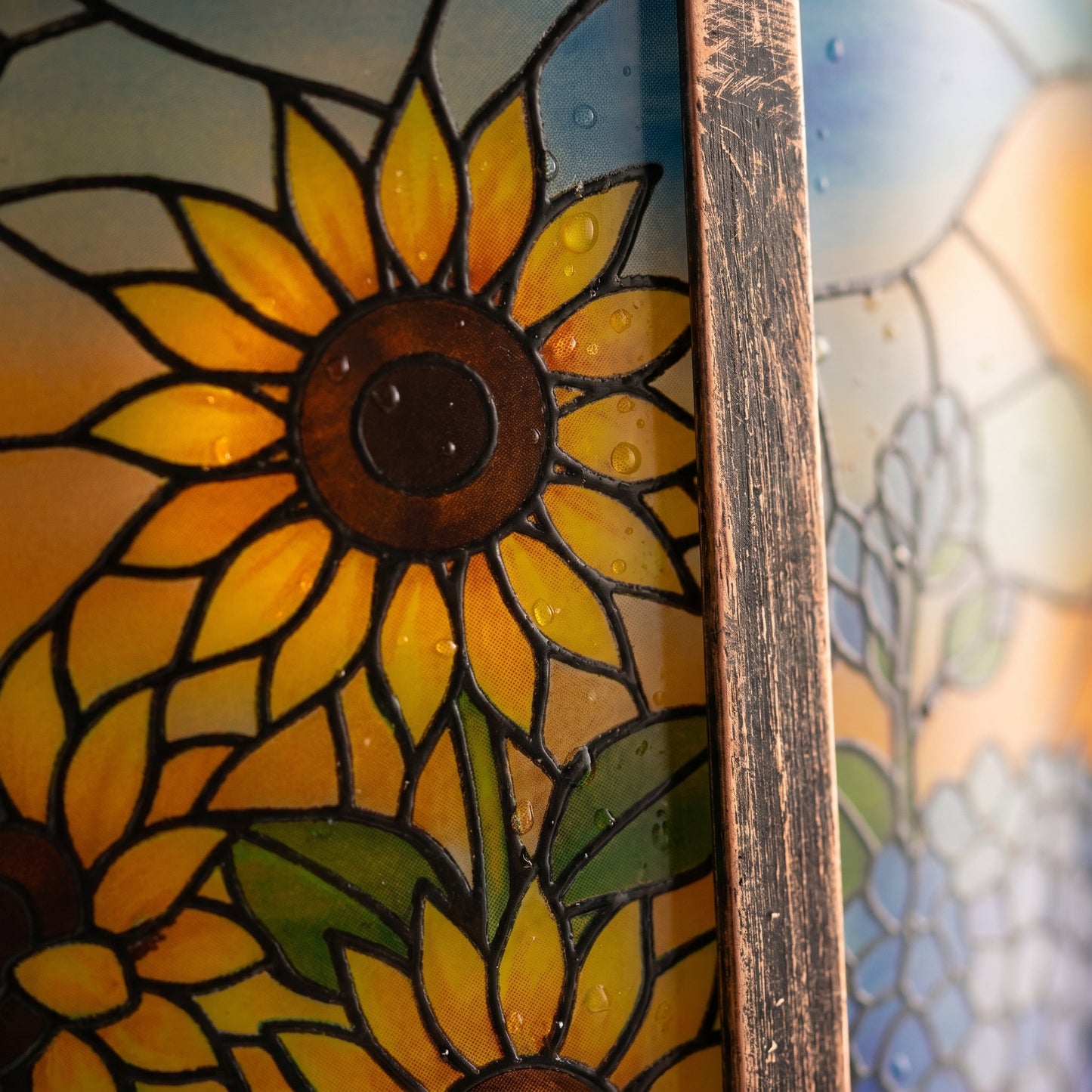 Close-up of the stained-glass-style panel and brushed antique bronze metal frame of the solar lantern