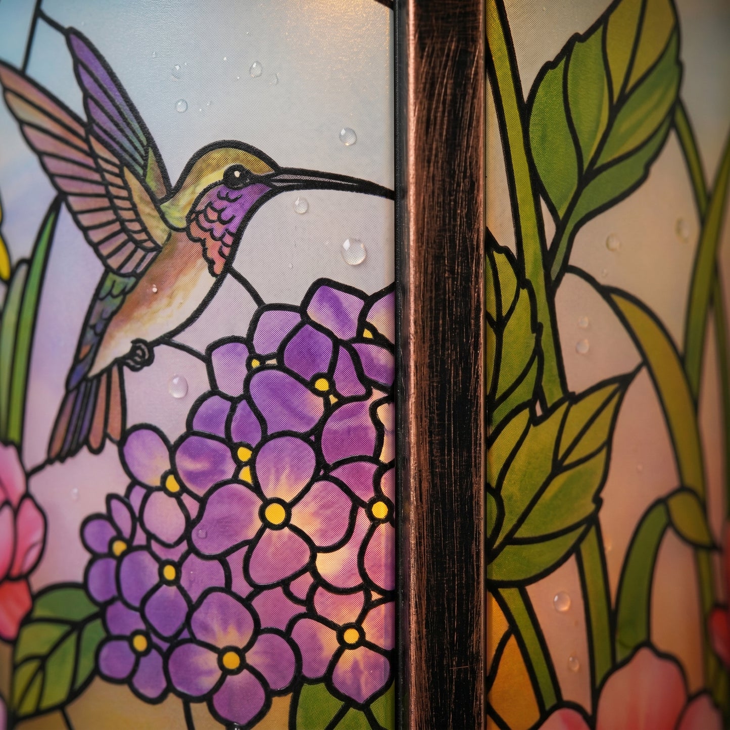 Close-up of the stained-glass-style panel and brushed antique bronze metal frame of the solar lantern